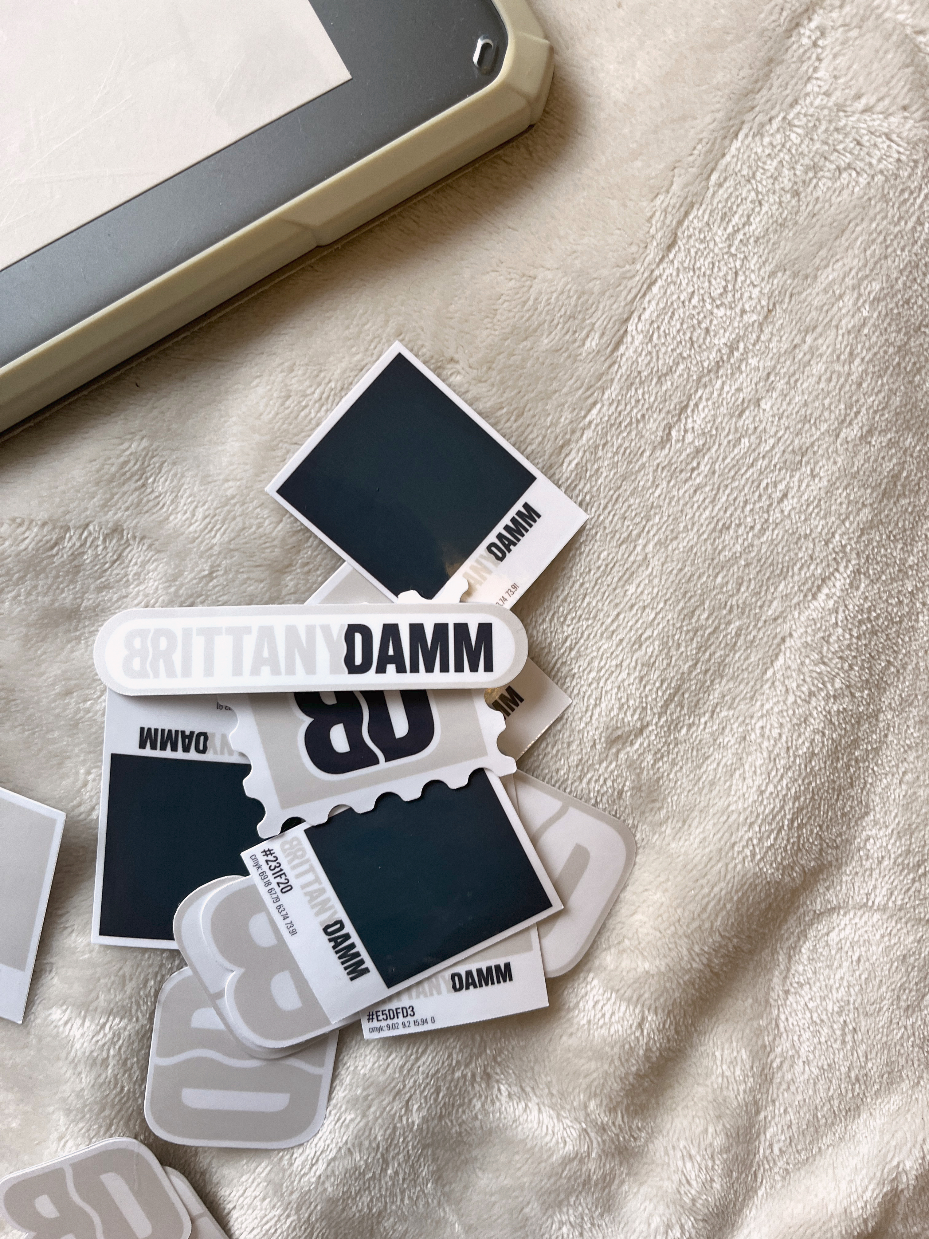 brand stickers thrown on white blanket background